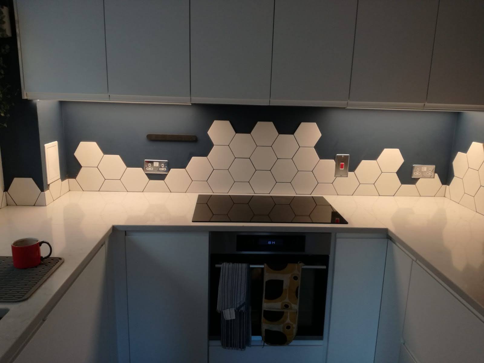 Hexagon tiled kitchen splashback fitted above an induction hob in a North London kitchen