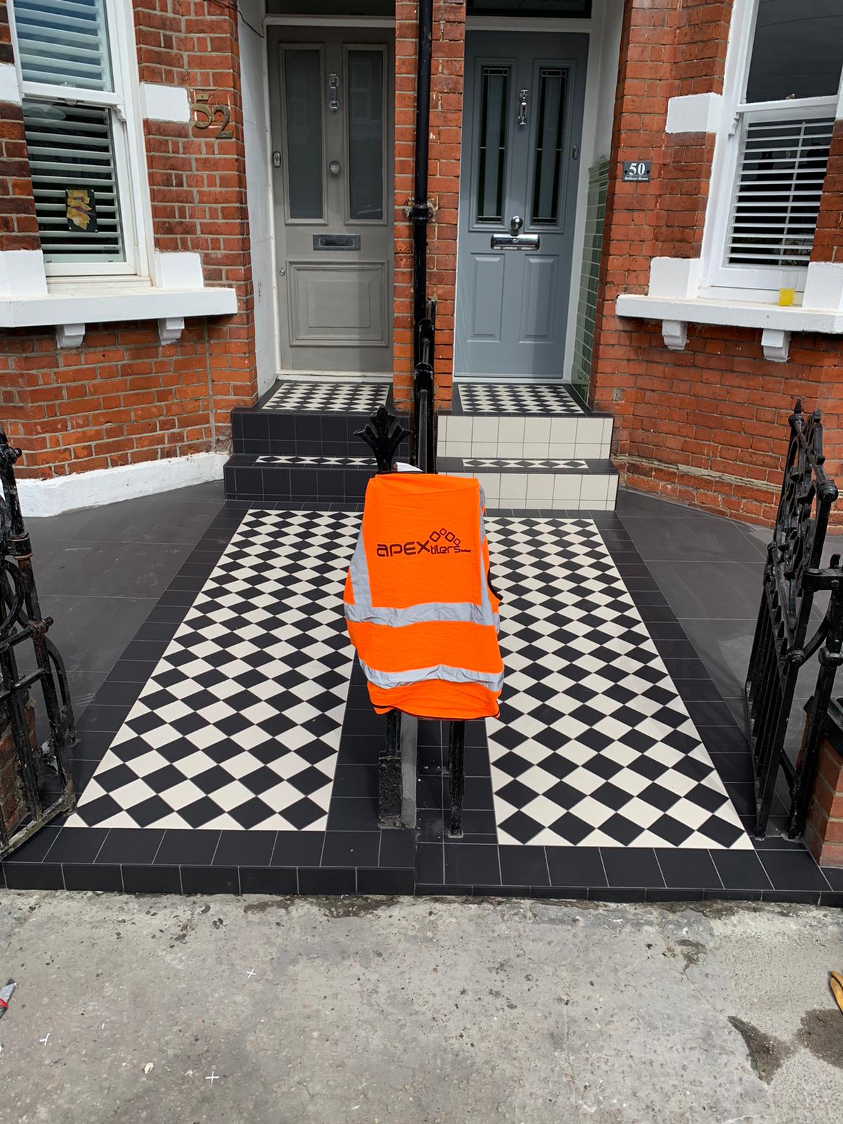 Black and white Victorian geometric tiled front path laid to a terraced house