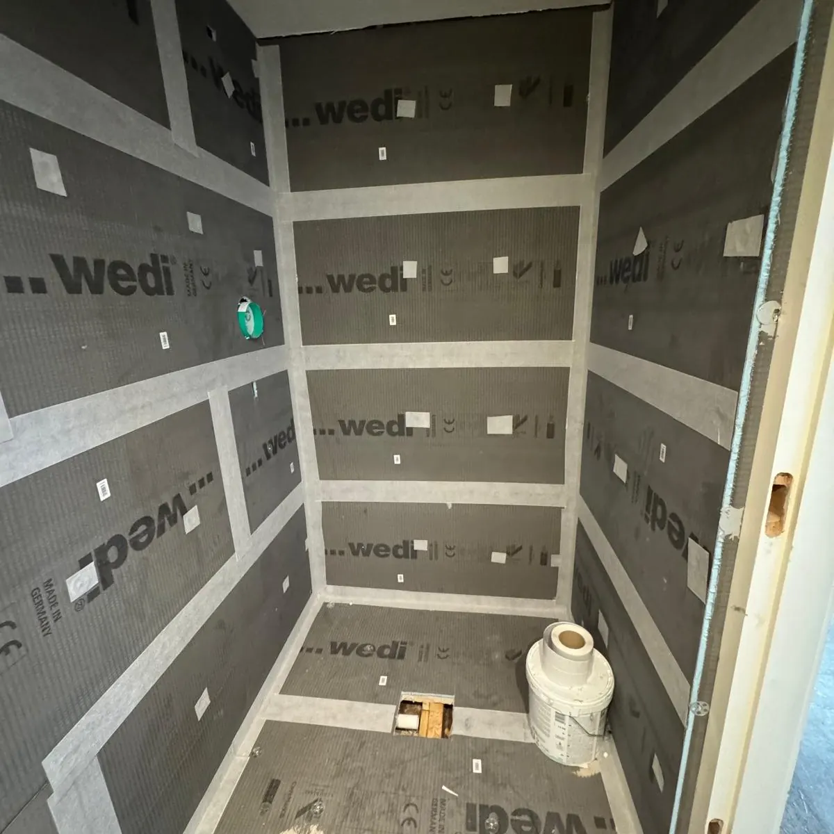 Wedi tile backer boards installed and jointed in a shower enclosure to form a fully tanked substrate